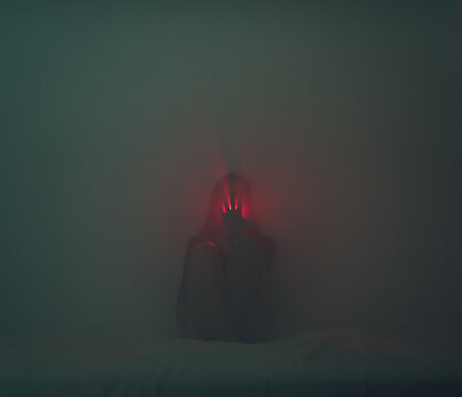 Hand covering a light coming from the mouth