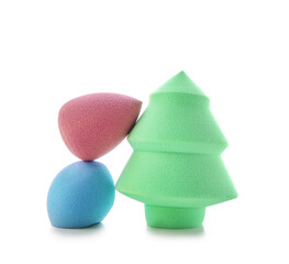 Stylish makeup sponges on white background