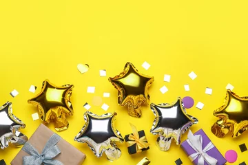 Poster Beautiful balloons and gift boxes on yellow background © Pixel-Shot
