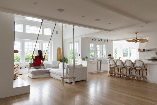 Child in Red Dress  on Swing indoors 