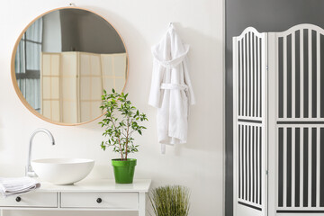 Stylish interior of modern bathroom with white bathrobe - obrazy, fototapety, plakaty