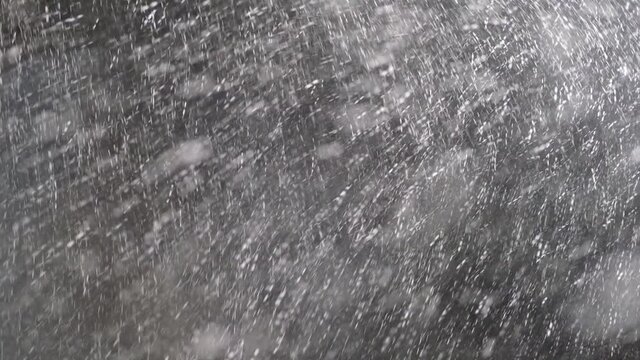 Real snow, falling snow blizzard, on the background of the night sky, in HD quality, which will be used to create compositions, motion graphics. Storm
