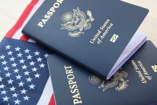 US passports on American flag background