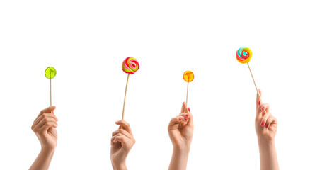 Women holding sweet lollipops on white background