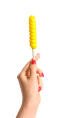 Woman holding yellow lollipop on white background