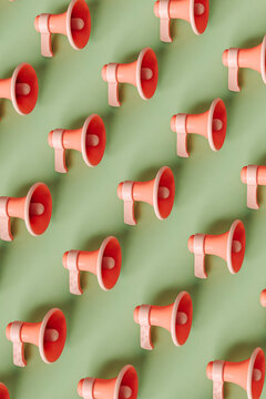 a pattern of megaphones  on a pastel green background