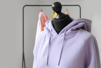 Mannequin with lilac hoodie in modern room, closeup