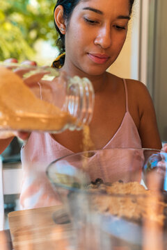 Pretty woman adding panela to the mixture