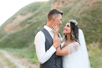 Happy wedding couple in countryside