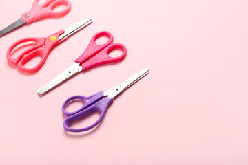 Many scissors on color background