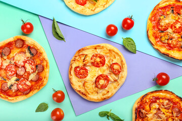 Delicious mini pizzas on color background