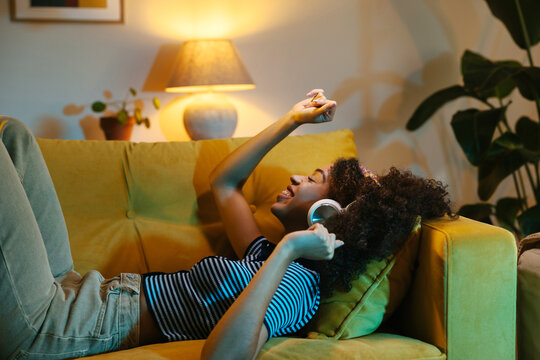 Black female dancing on sofa