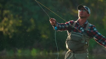 Fly fishing. Man fly fishing on the wild river with lots of insects flying in the air