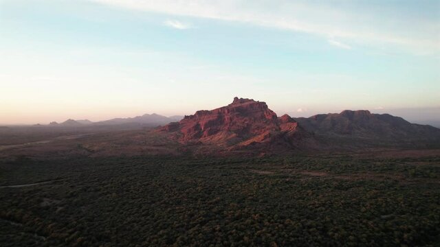 Cinematic Aerial of Red Mountain in Arizona Desert with Golden Sun Glow