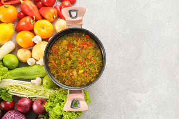 Cooking pot with delicious soup on white table