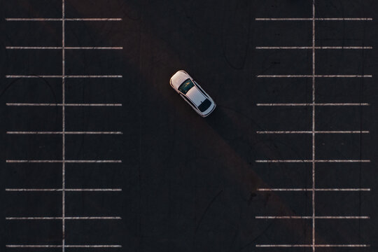  white sedan car in the parking, drone top-down view