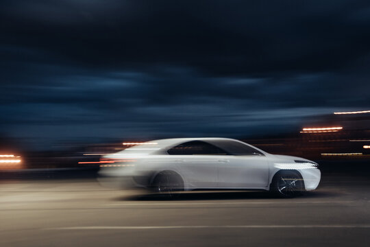 blurred night photo of a white sedan car