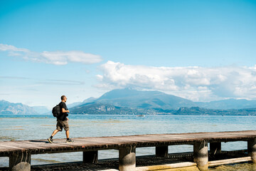 Traveler walking on pier near sea
