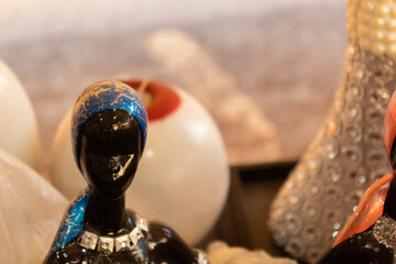 beautiful handmade ceramic and glass figurines of women for sale in a local market in oaxaca