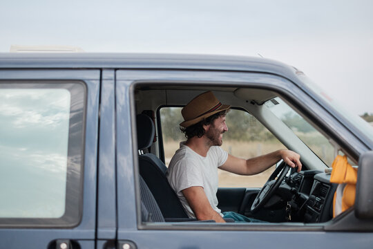 happy man drives a camper van