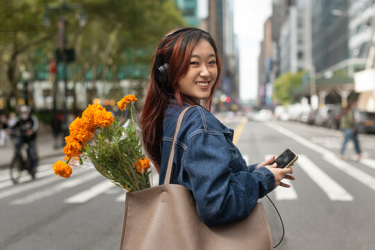 Young woman on the go smiling at camera
