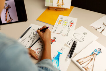 Designing fashion sketches on paper
