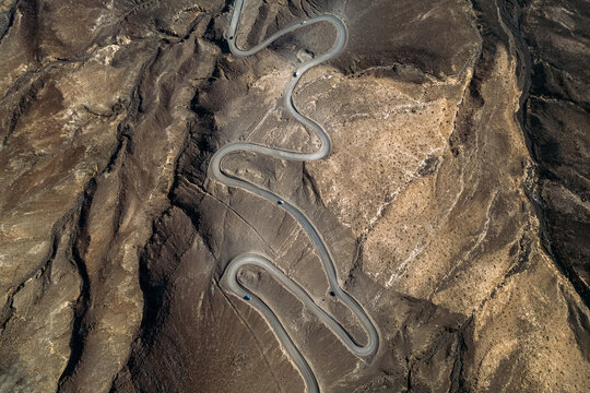 Cars riding along curved road