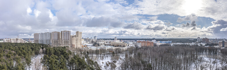 Fototapeta na wymiar aerial panoramic view of residential area near city park in winter. Minsk aerial view cityscape.