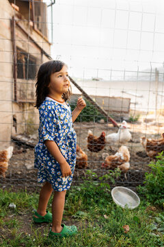 Little girl in chicken coop