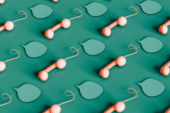 Pattern of pink vintage phone handsets and bubbles