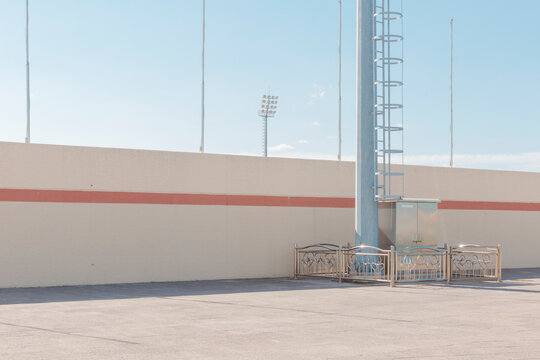 The walls of the outdoor stadium and several flagpoles.