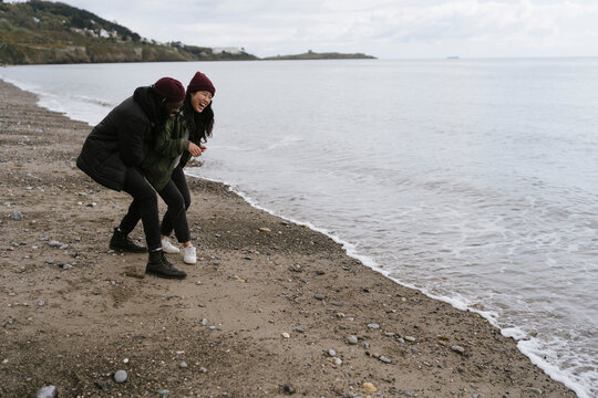 Young Couple is Playing with the Waves 