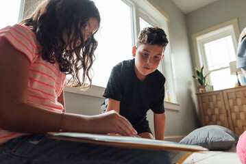 Brother helping sister with homework. 