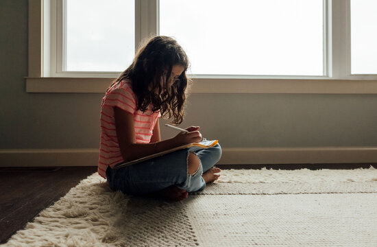 Child focused on homework. 
