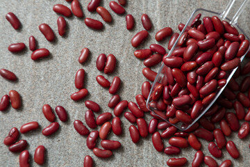 red bean in plastic spoon and a pie of red kedney bean studio shot