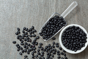 black bean in plastic spoon and white bowl