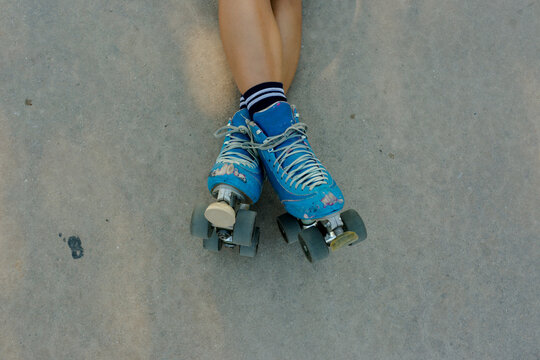 Blue vintage roller skates over concrete background