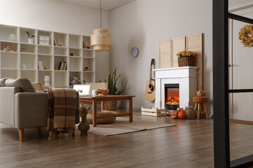 Interior of living room with autumn decor and fireplace