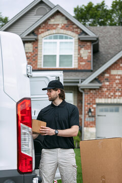 Shipment: Man Putting Box Onto Stack On Dolly