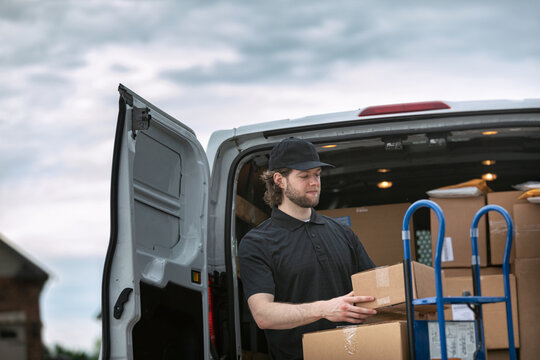 Shipment: Man Getting Boxes Out Of Delivery Van
