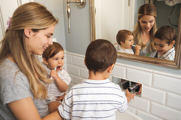 Family Brushing Teeth In The Bathroom