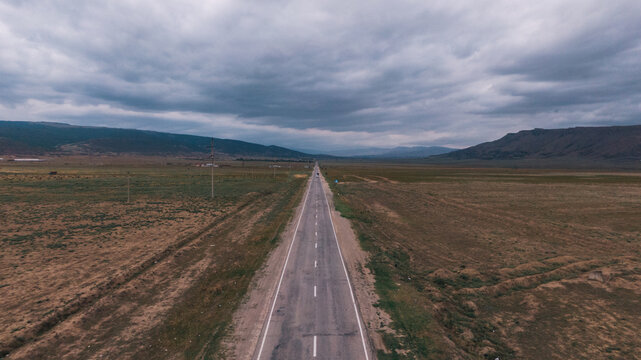 Drone view of a lonely road through the wastelands
