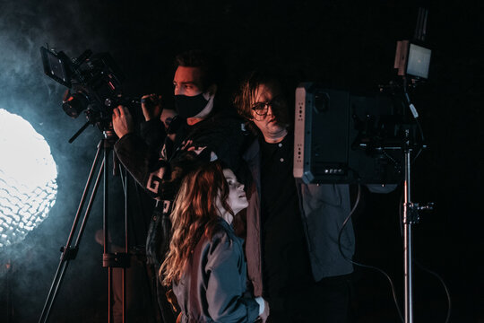 Film crew watches playback