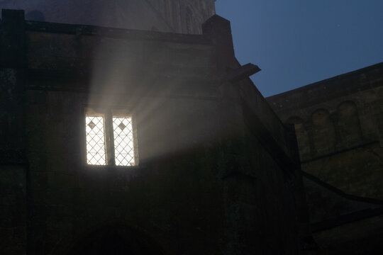 A window glowing in a church at night