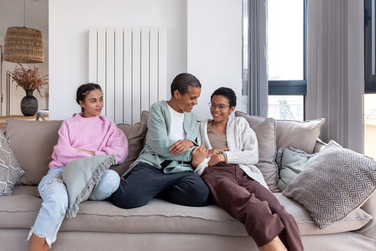 African American woman and teenagers on couch