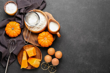 Fototapeta na wymiar Fresh ingredients for preparing pumpkin pie on black background