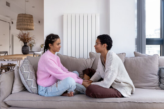 Two sisters chatting at home