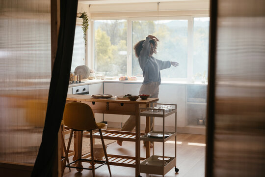 African American woman dancing in kitchen