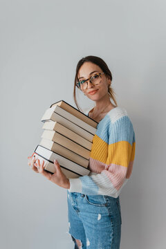 Portrait of woman with a lot of books