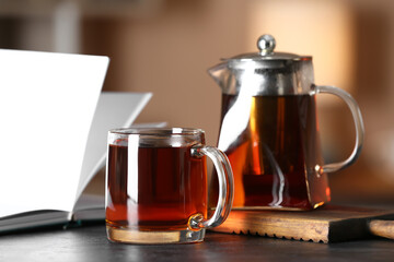 Glass cup of tasty tea on table in cafe